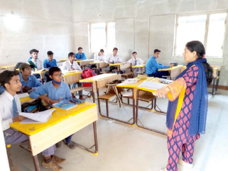a teacher takes a class at the government school in fb area which was retrieved from illegal occupants on the directives of the sindh ombudsman following a report published in the express tribune photo express