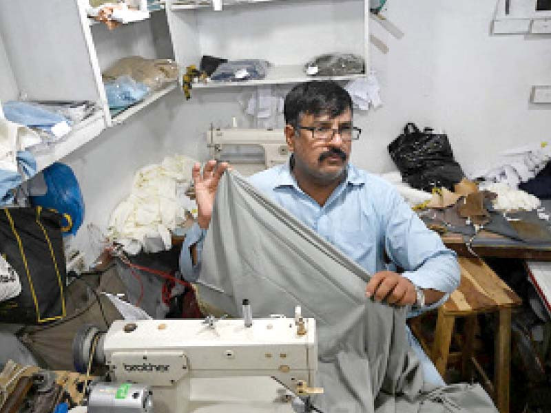 a tailor stitches clothes at his shop in rawalpindi photo express