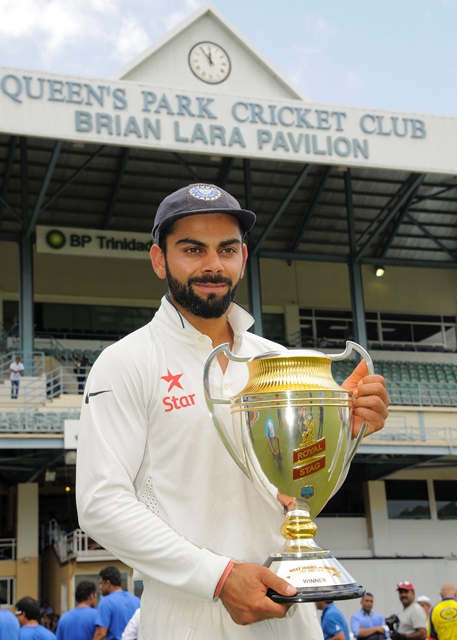 virat kohli holds the series trophy after play was abandoned at queen 039 s park oval in port of spain trinidad and tobago photo afp