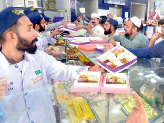 people rush to buy sweets at a confectionary shop in the city on the eve of eidul fitr photo jalal qureshi express people rush to buy sweets at a confectionary shop in the city on the eve of eidul fitr photo jalal qureshi express