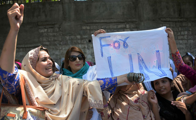 a kashmiri woman shouts slogan as she holds bangles during a protest with others in muzaffarabad the capital kashmir on august 23 2016 photo afp