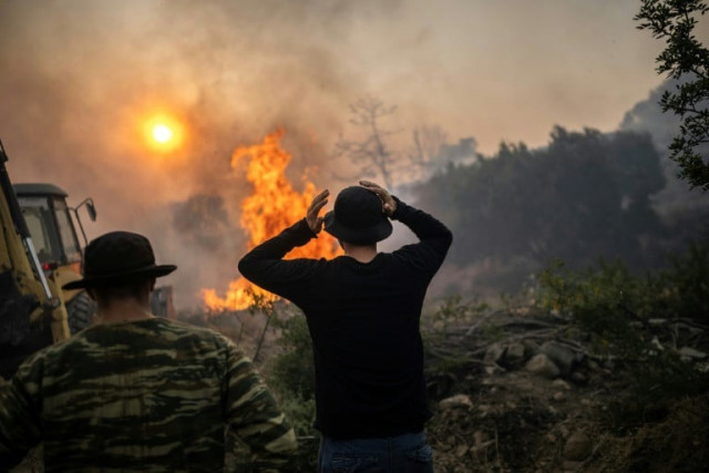wildfires have been raging in greece amid scorching temperatures forcing mass evacuations in several tourist spots including on the islands of rhodes and corfu photo afp wildfires have been raging in greece amid scorching temperatures forcing mass evacuations in several tourist spots including on the islands of rhodes and corfu photo afp