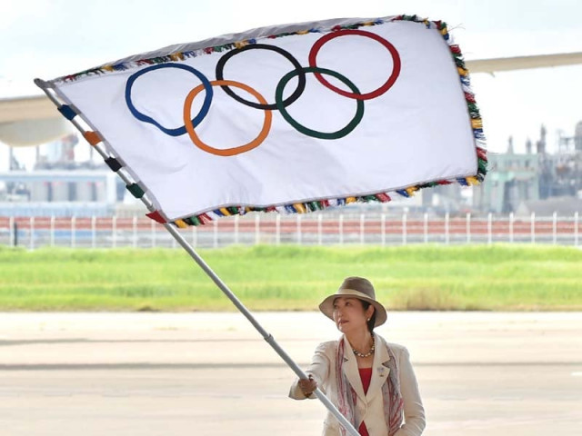 tokyo governor yuriko koike carried the flag during a ceremony at haneda airport after stepping off a plane from the brazilian host city accompanied by a delegation who picked up a record 41 medals in rio photo afp tokyo governor yuriko koike carried the flag during a ceremony at haneda airport after stepping off a plane from the brazilian host city accompanied by a delegation who picked up a record 41 medals in rio photo afp