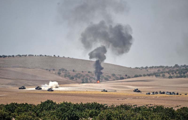 turkish army tanks and pro ankara syrian opposition fighter trucks positioned two kilometres west from the syrian turkish border town of jarabulus photo afp