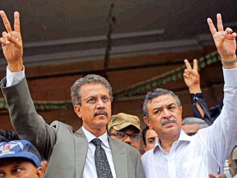 waseem akhtar and arshad vohra flash victory signs after winning the mayoral and deputy mayoral elections in karachi photo afp