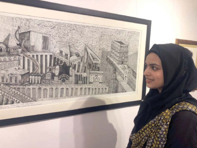 a visitor keenly observes art pieces on display at the artcade gallary in the federal capital photos express a visitor keenly observes art pieces on display at the artcade gallary in the federal capital photos express