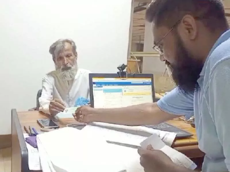 an elderly man gets his cnic renewed at a post office photo express an elderly man gets his cnic renewed at a post office photo express
