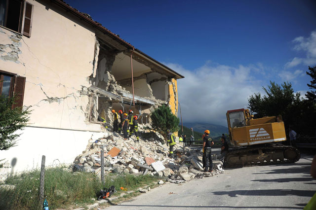 rescuers search for victims in damaged buildings after a strong heartquake hit amatrice on august 24 2016 photo afp