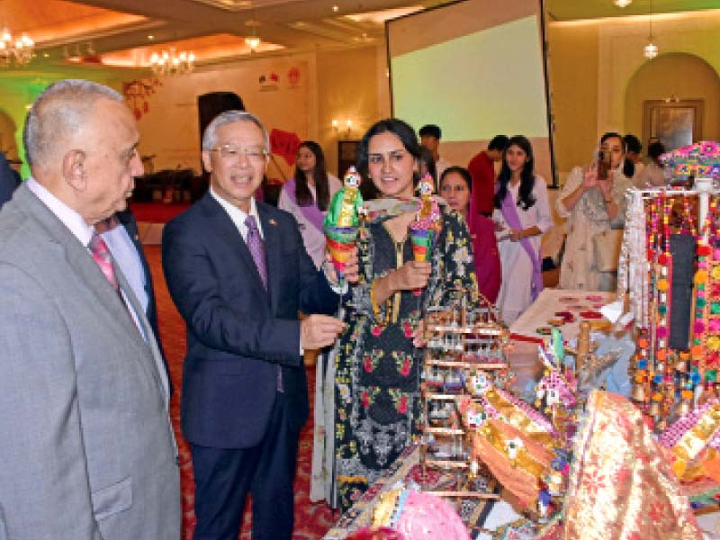 cultural counselor of the chinese embassy zhang heqing visits the stalls during the celebrations of 74th anniversary of the founding of china a decade of cpec and bri at a hotel in islamabad photo express