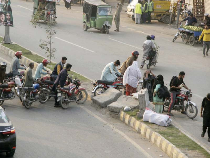 motorcyclists are forced to a detour due to roadblocks set up for the pml n rally at minar e pakistan photo nni