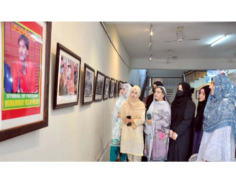 students view photographs put on display at an exhibition organised by the punjab arts council rawalpindi photo express
