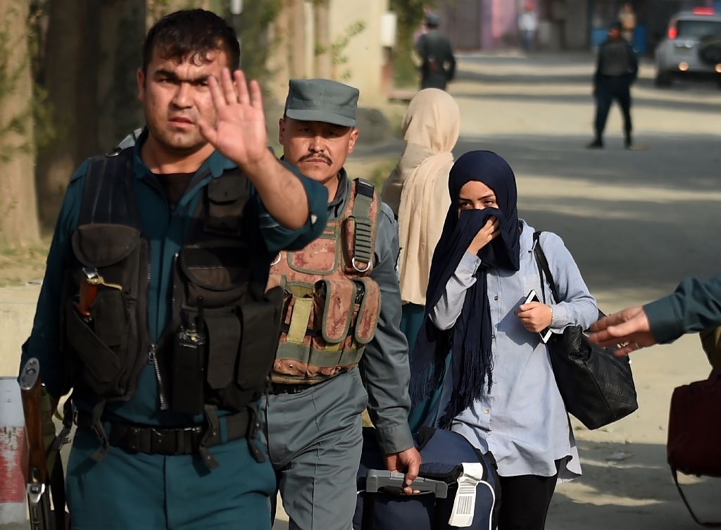 afghan women students who were trapped inside the american university of afghanistan in kabul during an attack by militants are escorted by police after a nearly 10 hour raid on august 25 2016 photo afp