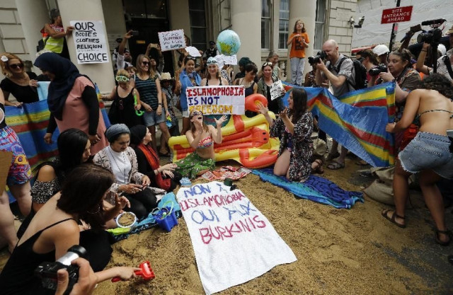 protestors carried placards with slogans such as quot burkini ban is racist quot and quot islamophobia is not freedom quot photo afp