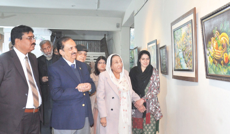 visitors keenly observe artworks at a two day painting exhibition titled mother nature at the punjab arts council in rawalpindi photo express