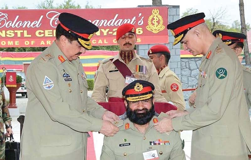 coas general raheel sharif pinning the badges of rank on the shoulders of lieutenant general asif mumtaz sukhera to formally install him as the colonel commandant of army medical corps in abbottabad photo app