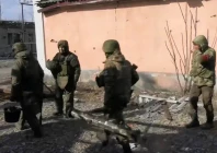 members of the russian military walk near a damaged building in a location given as avdiivka ukraine in this screen grab obtained from a social media video released february 22 2024 photo reuters