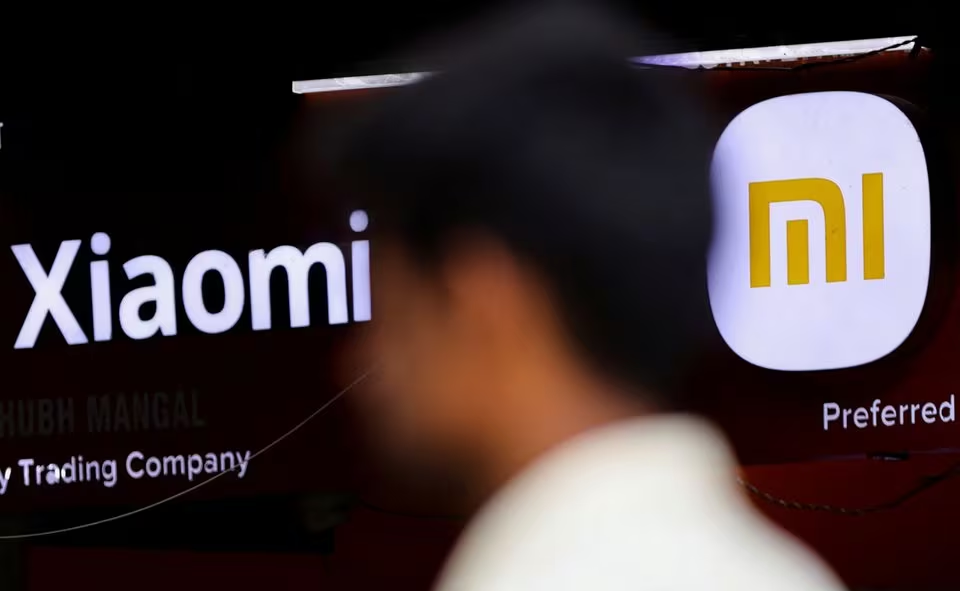 a man walks past a logo of xiaomi a chinese manufacturer of consumer electronics outside a shop in mumbai india may 11 2022 photo reuters file