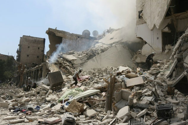 rescue workers search for victims through the rubble of a building destroyed during a reported barrel bomb attack in a rebel held neighbourhood of eastern aleppo northern syria on august 27 2016 photo afp