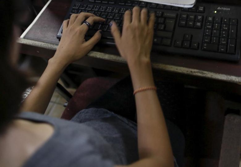 a woman uses the internet at an internet cafe in yangon myanmar february 5 2016 photo reuters