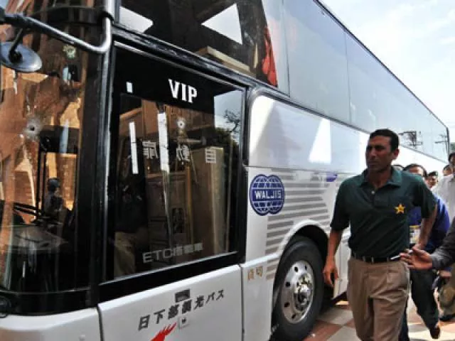 younus khan walks past the bullet ridden team bus in lahore on march 3 2009 photo afp younus khan walks past the bullet ridden team bus in lahore on march 3 2009 photo afp