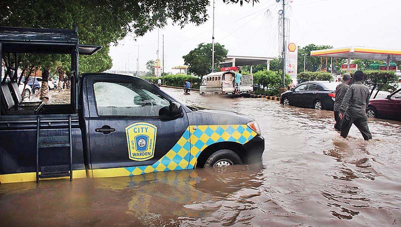 a vehicle of city wardens is stuck on an inundated road after it rained on sunday photo online