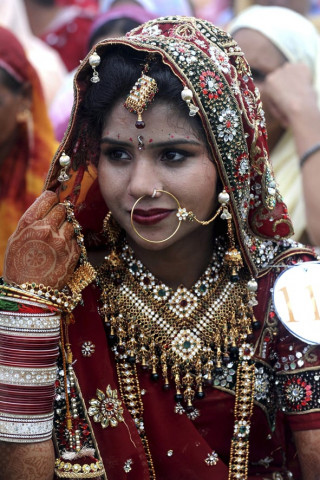an indian bride sits during a mass marriage ceremony for some 121 low income couples in an area on the outskirts of amritsar photo afp an indian bride sits during a mass marriage ceremony for some 121 low income couples in an area on the outskirts of amritsar photo afp