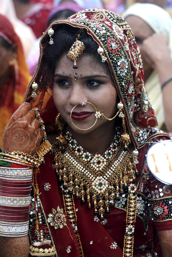 an indian bride sits during a mass marriage ceremony for some 121 low income couples in an area on the outskirts of amritsar photo afp