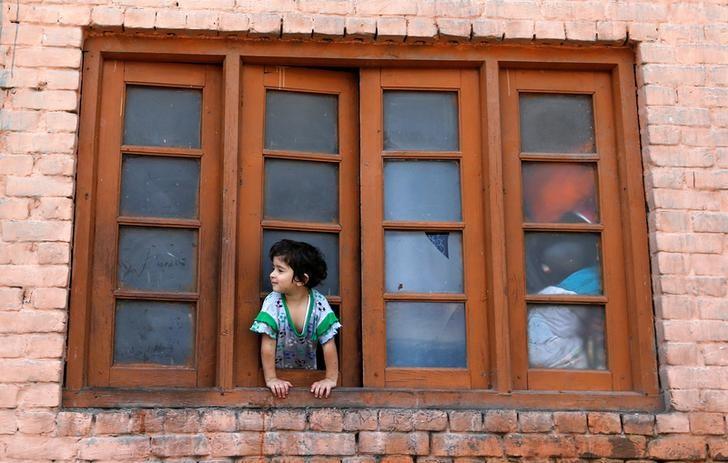 a girl looks out from a window of her house during a curfew in srinagar july 24 2016 photo reuters