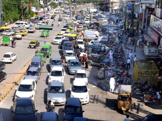 encroachments on a footpath next to a plaza on sixth road rawalpindi has become a cause of nuisance for motorists the footpath has been transformed into an illegal parking spot and is thronged by street vendors photo agha mehroz express