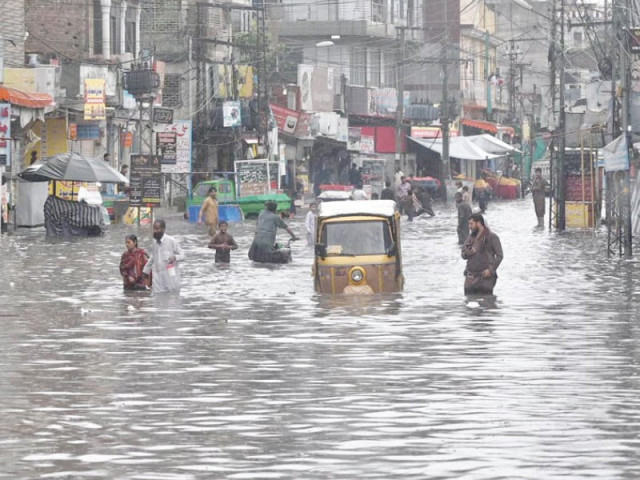 citizens navigate an inundated road in raja bazaar following heavy early morning downpour in the twin cities photos app inp citizens navigate an inundated road in raja bazaar following heavy early morning downpour in the twin cities photos app inp