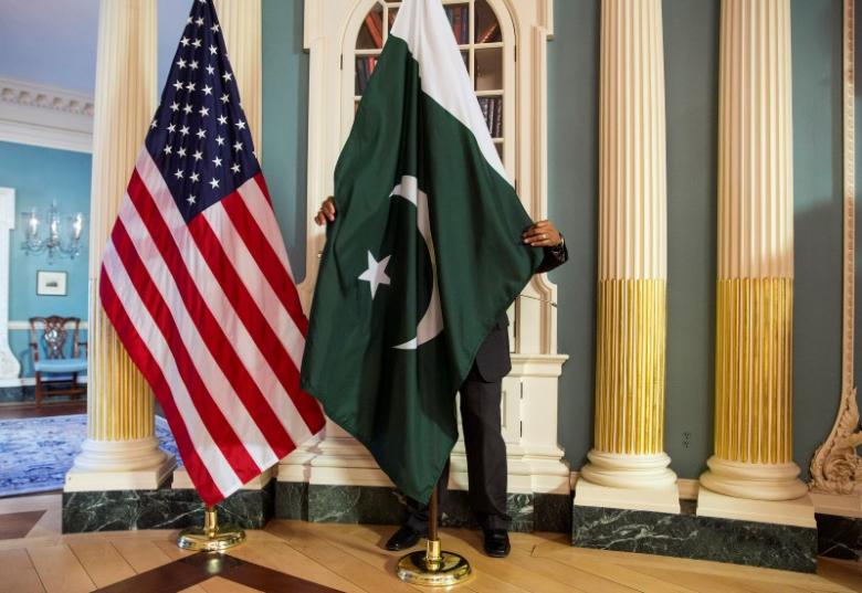 a state department contractor adjust a pakistan national flag before a meeting between u s secretary of state john kerry and pakistan 039 s interior minister chaudhry nisar ali khan on the sidelines of the white house summit on countering violent extremism at the state department in washington february 19 2015 reuters joshua roberts