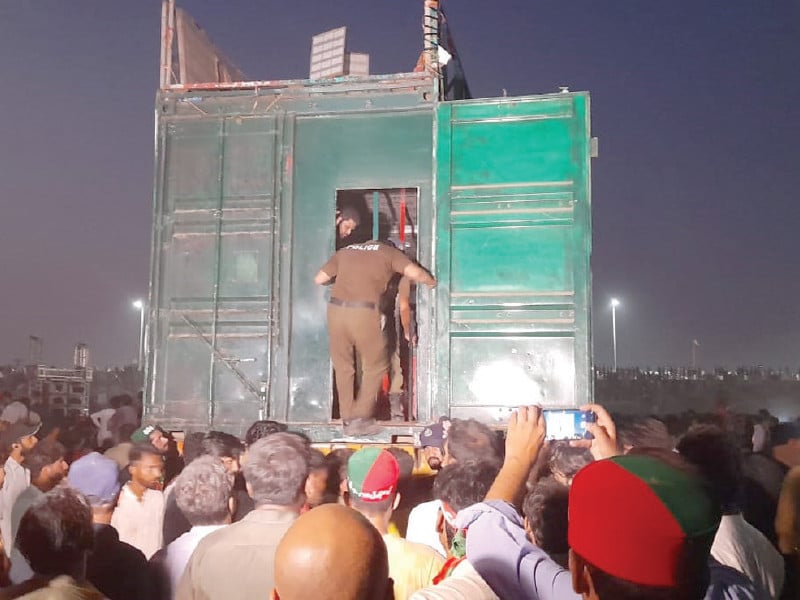 police officials enter the container hosting the pti leaders at the end of a deadline set by the administration to conclude the rally photo express