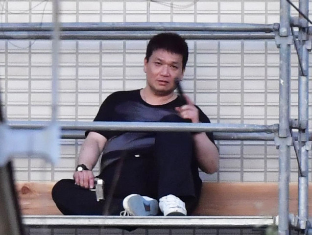 yasuhide mizobata fled into an apartment building on tuesday afternoon after firing repeatedly at officers who challenged him yasuhide mizobata fled into an apartment building on tuesday afternoon after firing repeatedly at officers who challenged him