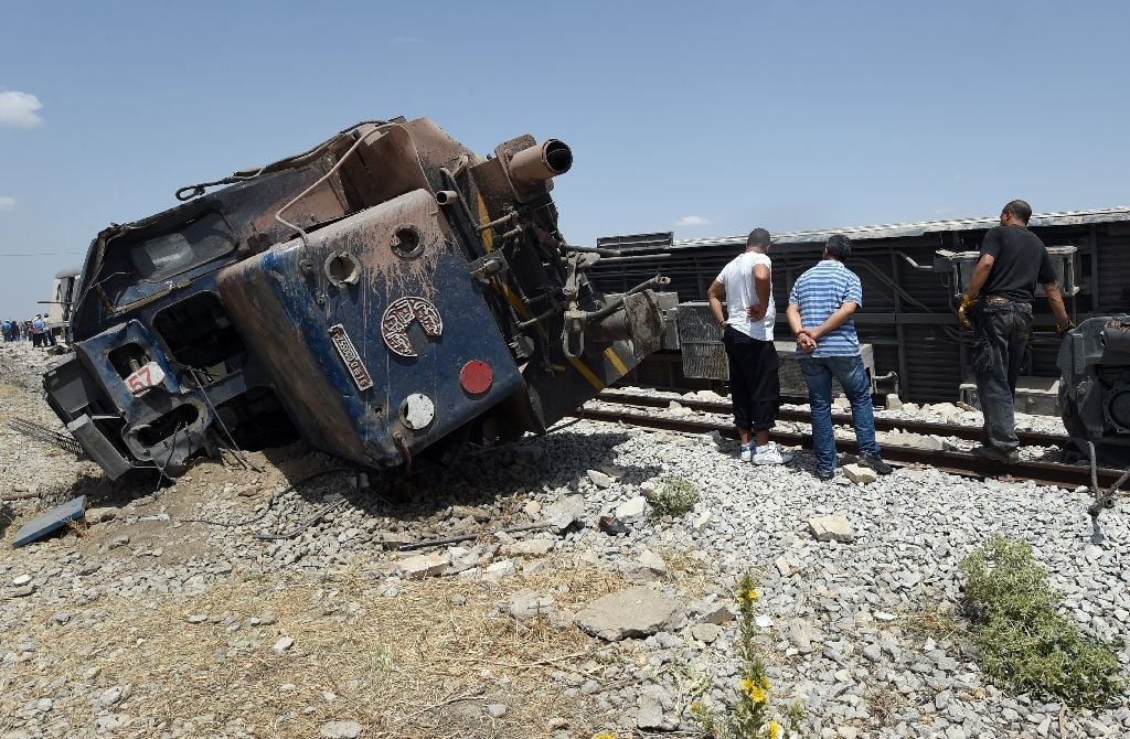 tunisians surround the carriages of a train after it derailed following a collision with a lorry killing at least 18 people near the town of el fahes on june 16 2015 photo afp