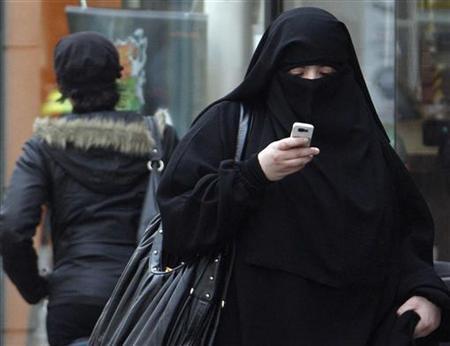 a woman wears a burqa as she walks on a street in saint denis near paris photo reuters