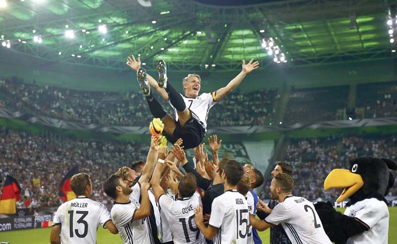 schweinsteiger is carried by his teammates on their shoulders as say goodbye to one of germany s longest serving stalwarts photo afp