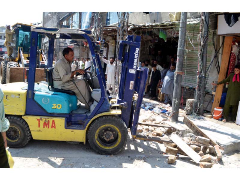 municipal officials razing an illegal structure photo agha mehroz express