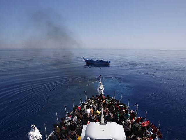 rescued italian police carry migrants to safety leaving their leaky boat to drift photo reuters