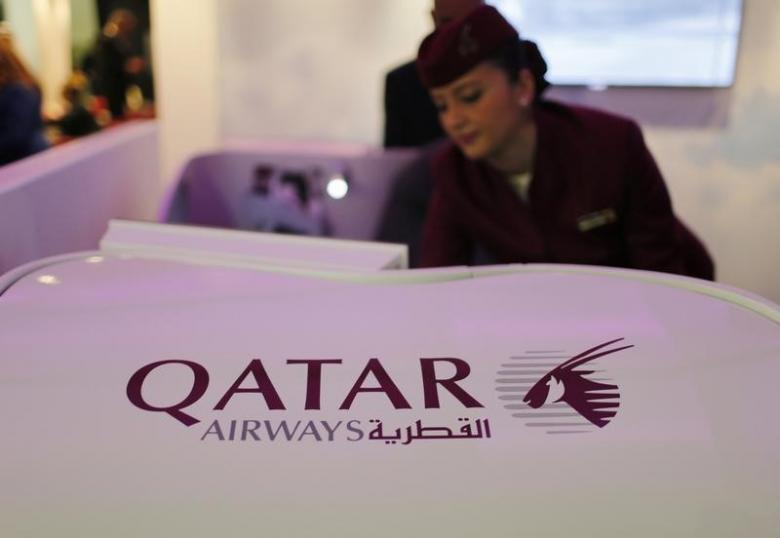 a qatar airways flight stewardess shows the airline 039 s new business class seat during the arabian travel market exhibition in dubai photo reuters