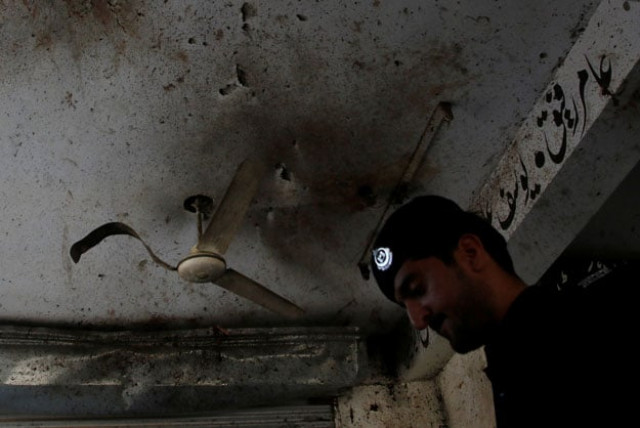 a policeman looks for evidence under a damaged ceiling after twin bomb attack occurred at a court in mardan september 2 2016 photo reuters a policeman looks for evidence under a damaged ceiling after twin bomb attack occurred at a court in mardan september 2 2016 photo reuters