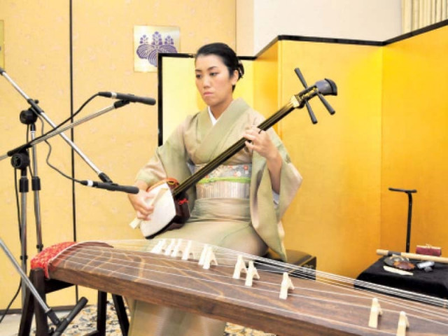japanese musician sumie kaneko playing the instrument shamisen photo express japanese musician sumie kaneko playing the instrument shamisen photo express