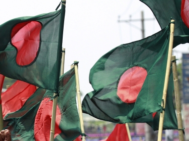 protesters march with national flags as they shout slogans during a labour day rally in dhaka may 1 2014 photo reuters