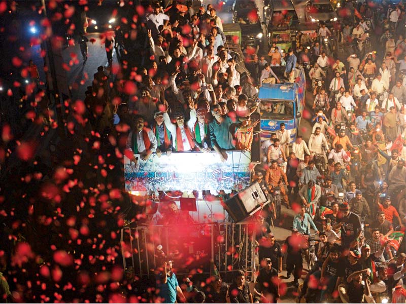 imran khan waves to his supporters in the ehtesab rally in lahore photo afp