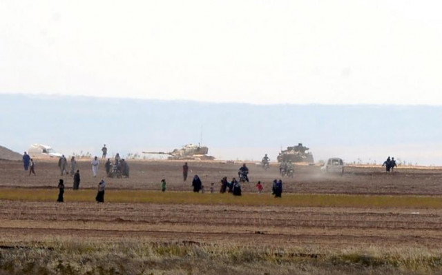 syrian civilians with turkish army tanks in the background walk through the turkish border as they are pictured from a village in kilis province turkey september 3 2016 photo reuters syrian civilians with turkish army tanks in the background walk through the turkish border as they are pictured from a village in kilis province turkey september 3 2016 photo reuters