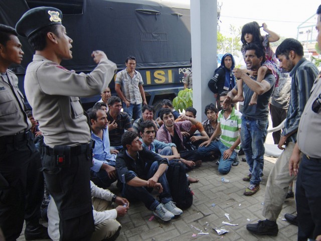 in this file photo asylum seekers from afghanistan and pakistan argue with indonesian policemen at a temporary shelter in merak indonesia 039 s banten province september 27 2013 photo reuters file