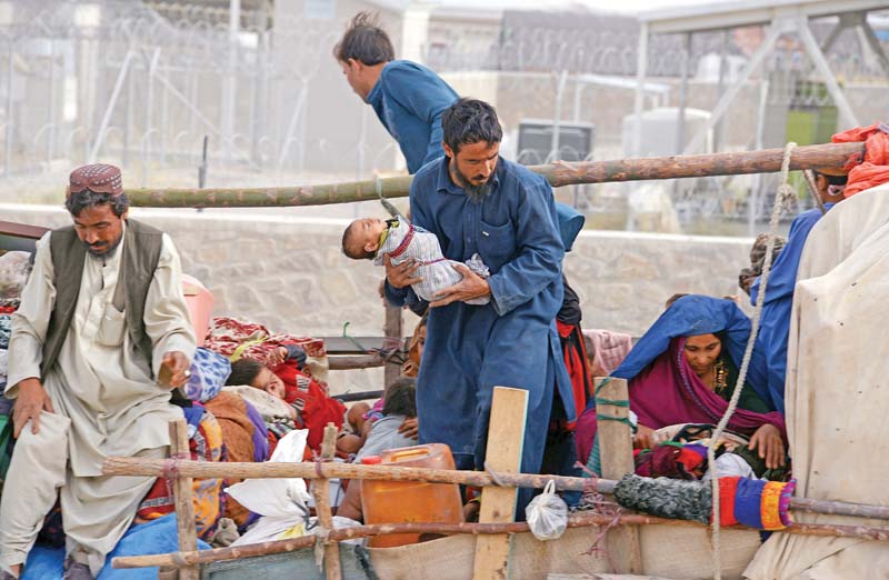 an afghan family prepares to leave pakistan at chaman border in balochistan photo file