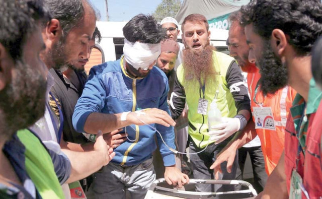volunteers help a wounded man outside a hospital in indian kashmir photo inp volunteers help a wounded man outside a hospital in indian kashmir photo inp