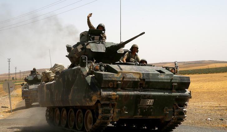 a turkish soldier on an armoured personnel carrier waves as it is driven from the border back to their base in karkamis on the turkish syrian border in the southeastern gaziantep province turkey august 27 2016 photo reuters