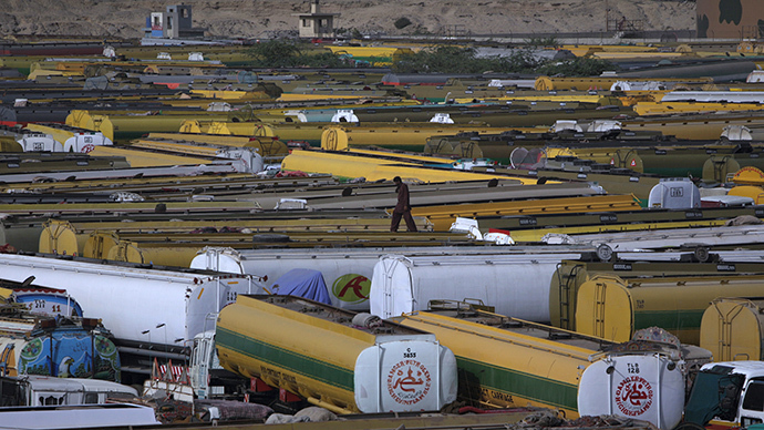 a man walks atop of fuel tankers which were used to carry fuel for nato forces in afghanistan photo reuters