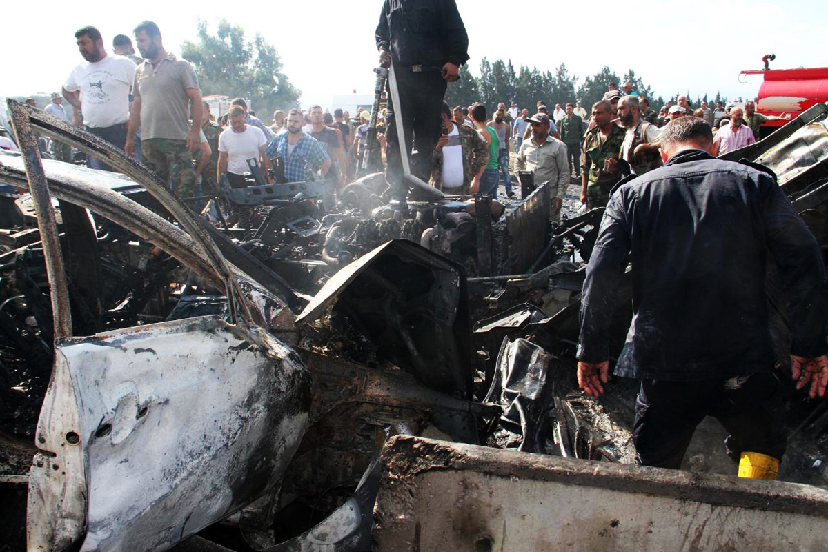 a handout picture released by the official syrian arab news agency sana on september 5 2016 reportedly shows syrians and security forces gathering at the site of a blast targeting the arzuna bridge in a government held area outside the syrian city of tartus photo afp